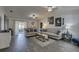 Spacious living area with dark wood-look floors, comfy seating, and large TV at 3960 Lema Dr, Spring Hill, FL 34609