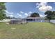 Backyard view showcasing above ground pool and green lawn at 3960 Lema Dr, Spring Hill, FL 34609