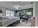 Main bedroom with a workspace, large bed, and ceiling fan at 3960 Lema Dr, Spring Hill, FL 34609
