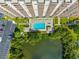 Top down view of a refreshing pool and a pond at 7050 Sunset S Dr # 1504, South Pasadena, FL 33707