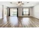 Bright living room with hardwood floors and sliding glass doors to patio at 19492 Fort King Run, Brooksville, FL 34601