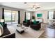 Bright and airy living room with large windows, modern furniture, and a marble coffee table at 19492 Fort King Run, Brooksville, FL 34601