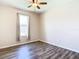 Well-lit bedroom with wood-look floors and neutral walls at 19492 Fort King Run, Brooksville, FL 34601