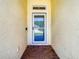 Front entrance with a glass door and brick flooring at 19492 Fort King Run, Brooksville, FL 34601