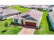 House nestled in a community with a pond and lush green spaces at 19492 Fort King Run, Brooksville, FL 34601