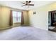 Spacious bedroom with ceiling fan and window at 19492 Fort King Run, Brooksville, FL 34601