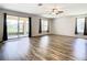 Spacious living area with hardwood floors and access to a back patio at 19492 Fort King Run, Brooksville, FL 34601