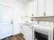 Bright laundry room with white cabinets, LG washer and dryer at 19492 Fort King Run, Brooksville, FL 34601