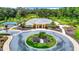Community clubhouse with circular driveway and flag at 19492 Fort King Run, Brooksville, FL 34601