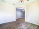 Open living room with wood-look floors and access to dining area at 19492 Fort King Run, Brooksville, FL 34601