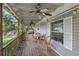 Relaxing covered porch with ceiling fans and wooden chairs at 9520 Merton St, New Port Richey, FL 34654