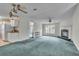 Spacious living room with fireplace and teal carpet at 9520 Merton St, New Port Richey, FL 34654
