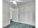 Simple bedroom with carpet, ceiling fan, and multiple doors at 9520 Merton St, New Port Richey, FL 34654