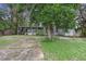 Single-wide mobile home with covered porch and a large yard at 9520 Merton St, New Port Richey, FL 34654