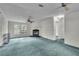 Spacious living room with fireplace and teal carpet at 9520 Merton St, New Port Richey, FL 34654