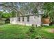 Mobile home with visible AC unit and lush green grass at 9520 Merton St, New Port Richey, FL 34654