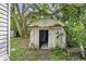 Rustic metal shed with open door, showing age and wear at 9520 Merton St, New Port Richey, FL 34654