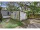 Old, weathered storage shed in the backyard at 9520 Merton St, New Port Richey, FL 34654