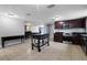 Modern kitchen with dark cabinetry, granite counters, and stainless steel appliances at 7446 Donegal St, New Port Richey, FL 34653