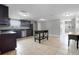 Open kitchen features dark cabinetry, kitchen island, and tile flooring at 7446 Donegal St, New Port Richey, FL 34653