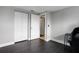 Simple office space with dark flooring and double door closet at 7446 Donegal St, New Port Richey, FL 34653
