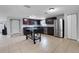 Modern kitchen with dark cabinets, stainless steel appliances and kitchen island at 7446 Donegal St, New Port Richey, FL 34653