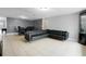 Living room with leather sectional sofa and dark tile flooring at 7446 Donegal St, New Port Richey, FL 34653
