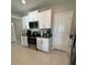 Kitchen with white cabinets, granite countertops, and stainless steel appliances at 15434 Miller Creek Dr, Sun City Center, FL 33573