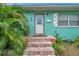 Front door entrance with brick steps and tropical plants at 800 61St N St, St Petersburg, FL 33710