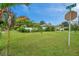 Large grassy yard with a palm tree and street view at 800 61St N St, St Petersburg, FL 33710