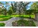 Expansive backyard with mature trees and lush green grass, providing ample space for outdoor activities at 11621 Colt Way, Hudson, FL 34669