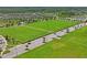 Aerial view of community with sports fields, parking, and green spaces at 3893 Burdick Loop, Odessa, FL 33556