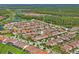 Aerial view showcasing the home's location near a pond and wooded area at 3893 Burdick Loop, Odessa, FL 33556