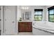 Bathroom showcasing granite-topped vanity, garden tub, and large window at 3893 Burdick Loop, Odessa, FL 33556