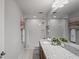 Well-lit bathroom showcasing a granite countertop vanity, a tub with shower, and neutral decor at 3893 Burdick Loop, Odessa, FL 33556