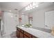 Bright bathroom featuring granite counters, ample vanity space, and a shower-tub combination with white tile at 3893 Burdick Loop, Odessa, FL 33556