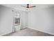Bedroom features a ceiling fan, a window with curtains, and gray walls at 3893 Burdick Loop, Odessa, FL 33556