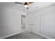 Bright bedroom features an open doorway, closet, ceiling fan, and neutral walls at 3893 Burdick Loop, Odessa, FL 33556