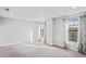 Spacious bedroom featuring two windows with curtains at 3893 Burdick Loop, Odessa, FL 33556