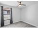 Bedroom features a window with curtains and gray walls at 3893 Burdick Loop, Odessa, FL 33556