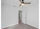 Neutral bedroom features an open doorway, ceiling fan, and neutral carpet at 3893 Burdick Loop, Odessa, FL 33556