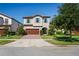 Lovely two-story home with a two-car garage, accented by light turquoise shutters, and a beautifully landscaped yard at 3893 Burdick Loop, Odessa, FL 33556