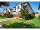 Exterior view of a two-story home with beautiful lawn, paver driveway, two-car garage, and well-kept landscaping at 3893 Burdick Loop, Odessa, FL 33556