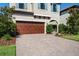 Charming two-story home featuring a two-car garage, paved driveway, and beautifully landscaped front yard at 3893 Burdick Loop, Odessa, FL 33556