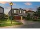 Beautiful home with a well-manicured lawn, lamp post, and a two-car garage at dusk at 3893 Burdick Loop, Odessa, FL 33556