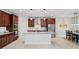 Well-equipped kitchen with stainless steel appliances, dark wood cabinetry, granite countertops, and an island at 3893 Burdick Loop, Odessa, FL 33556