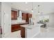 Bright kitchen featuring a center island, stainless steel appliances, dark wood cabinets, and an exhaust hood at 3893 Burdick Loop, Odessa, FL 33556
