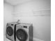 Laundry room features modern washer and dryer with white shelving and utility hook-ups at 3893 Burdick Loop, Odessa, FL 33556
