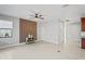 Open-concept space with modern tile floors, natural light, a feature wall, and hallway access at 3893 Burdick Loop, Odessa, FL 33556