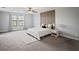 Spacious main bedroom with large windows, soft carpet, and a decorative accent wall for a modern feel at 3893 Burdick Loop, Odessa, FL 33556